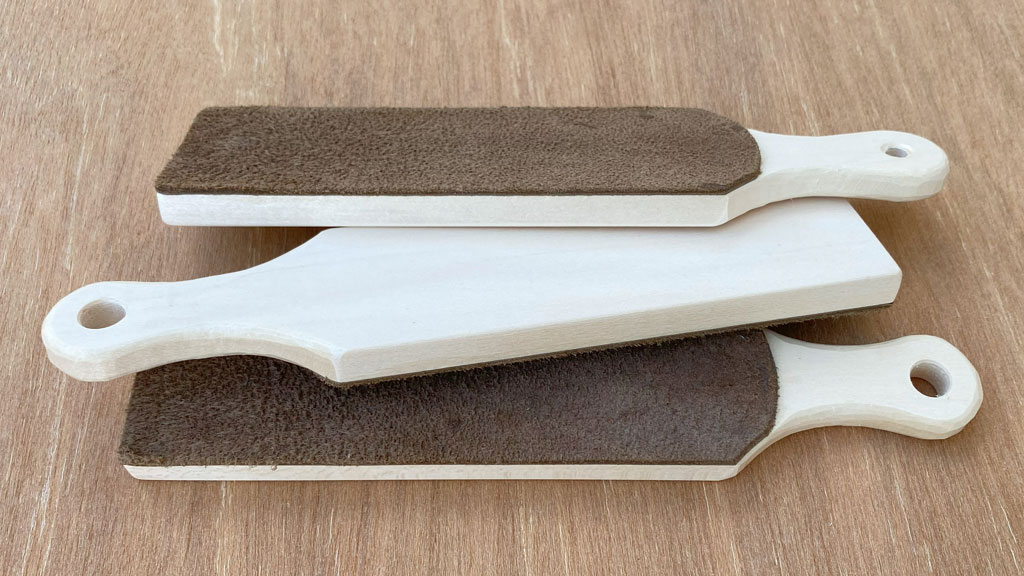 Three strops with whittled handles for woodcarving knives made by Roman Chernikov. Roman donated those strops to the SCVC woodcarving club. The photo was taken for the woodcarving newsletter.