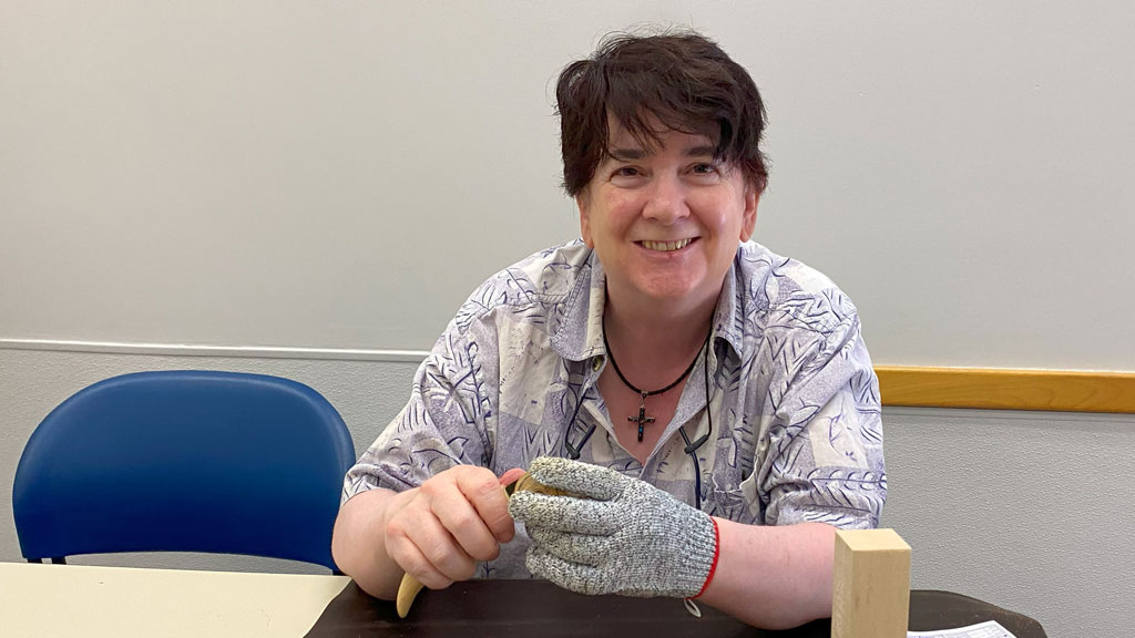 Terry whittles a pumpkin