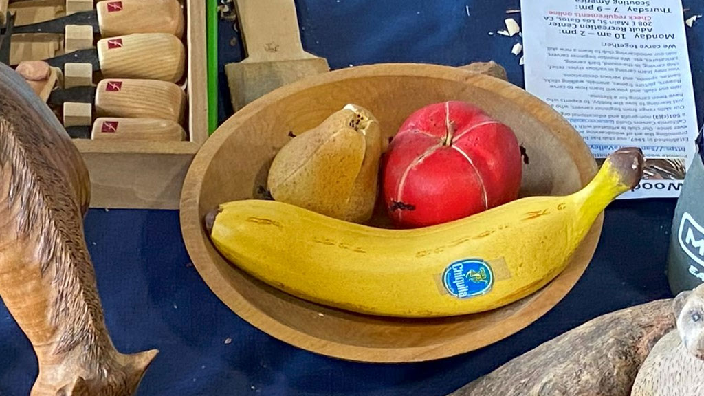 A bowl with wooden fruits carved from basswood by Theda.