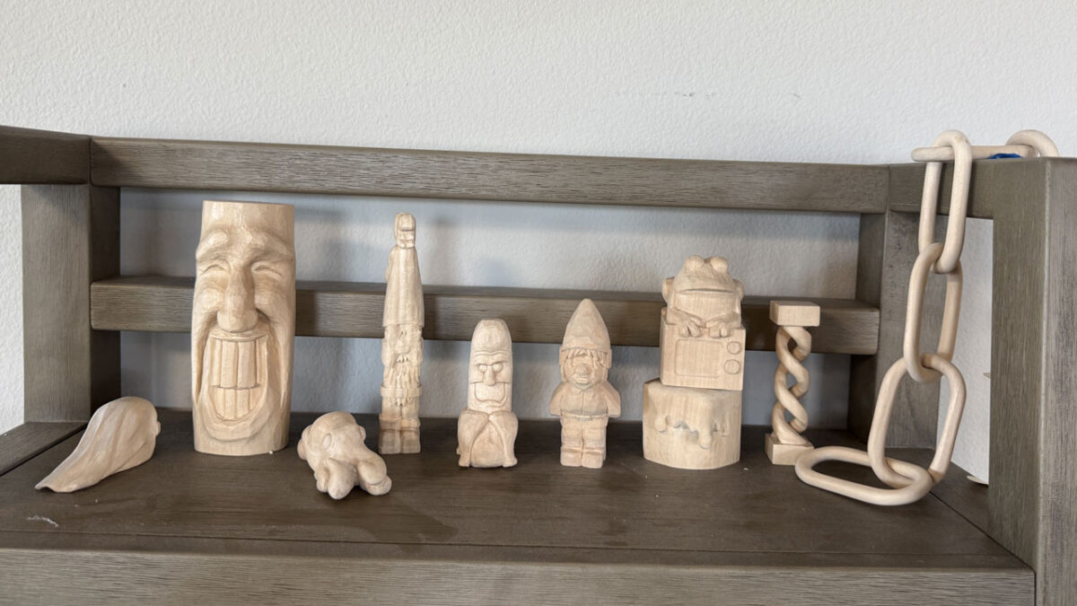 Several woodcarving projects, including a chain carved from a piece of basswood.