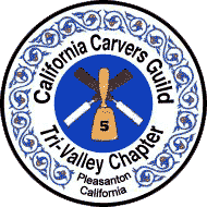 A round logo of the Tri-Valley Carvers, a chapter of the California Carvers Guild