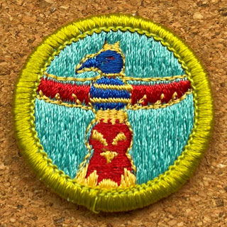 A round glue-on badge: Wood Carving Merit Badge