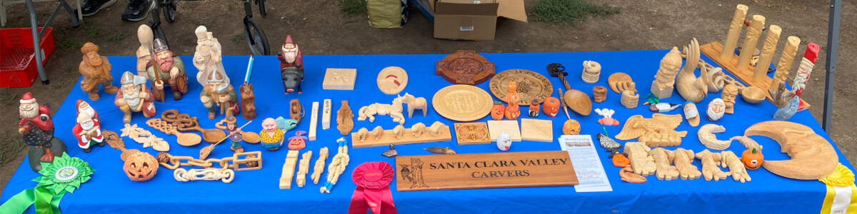 A display table with dozens of woodcarving and whittling projects.