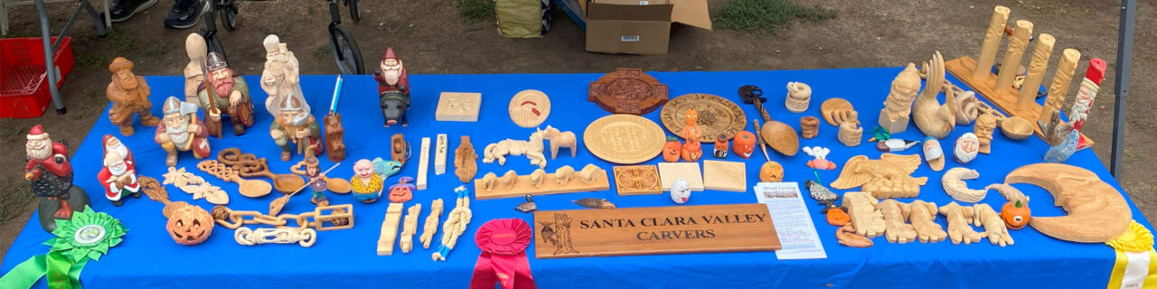 A display table with dozens of woodcarving and whittling projects.