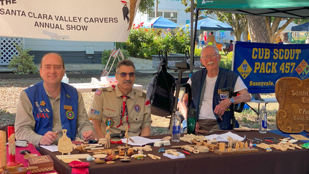 Woodcarving booth at Scout-O-Rama, 2025. Left to right: Roman Chernikov, Mike Campi, David Osterlund