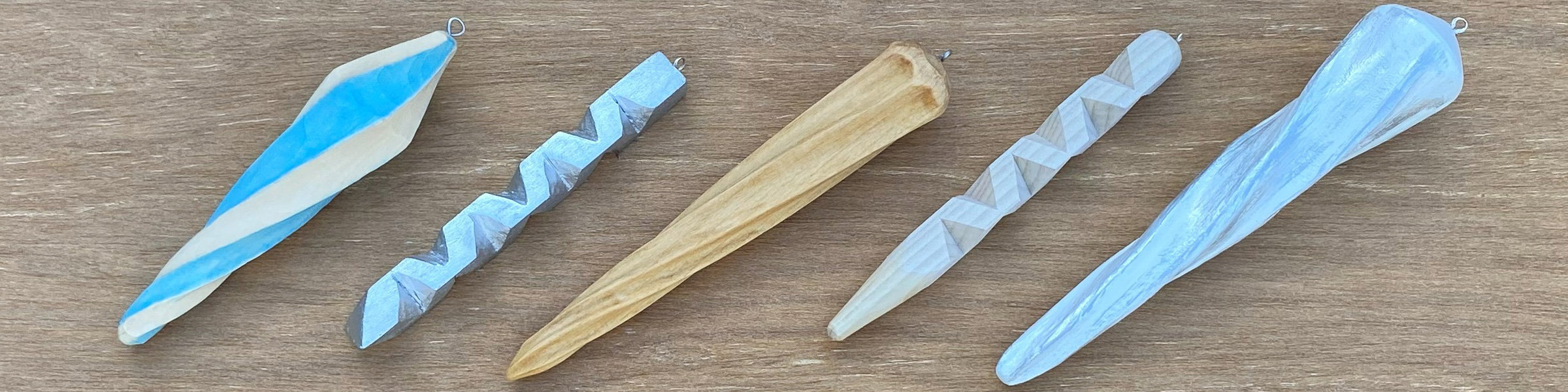 Five wooden icicle hand-carved by members of the Santa Clara Valley Carvers: Roman Chernikov, David Clarke, and Dan Brady.