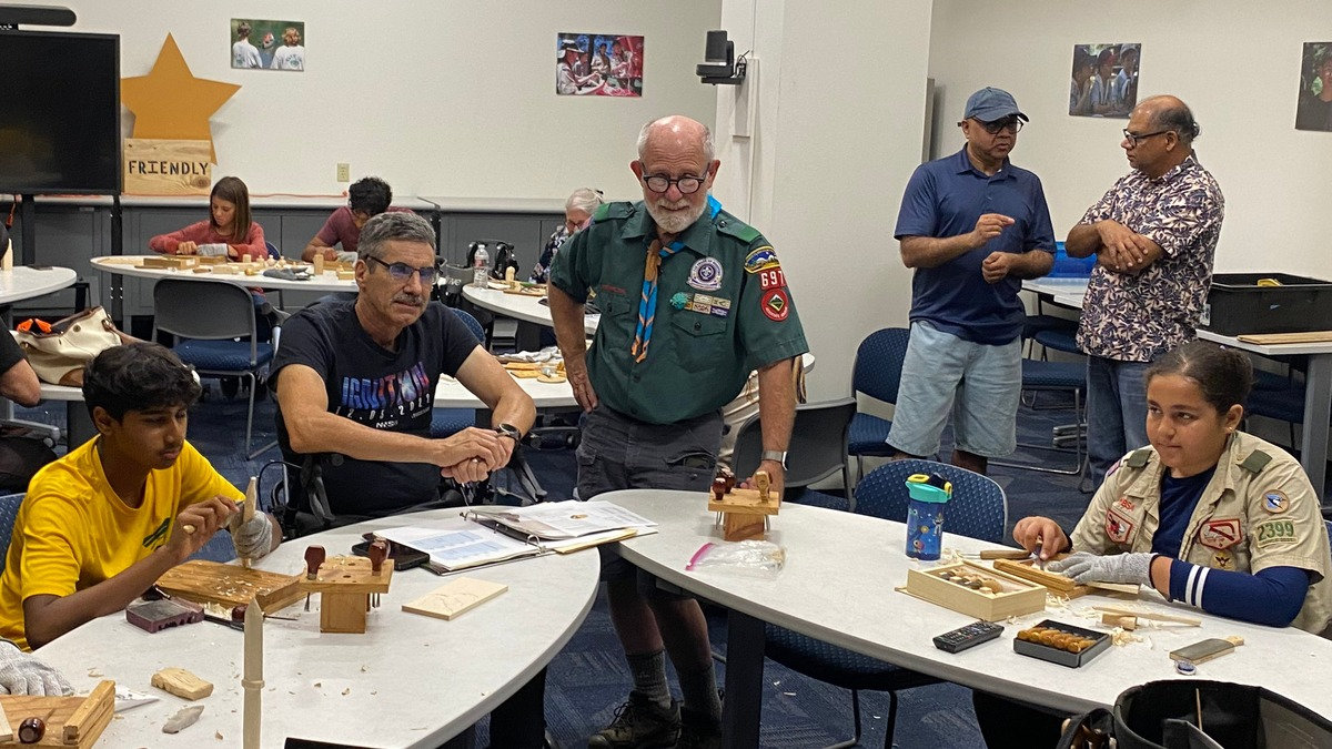 Members of the Santa Clara Valley Carvers, including Dan Brady, Mike Campi, and Nitin Varshney, lead a Woodcarving Merit Badge workshop for local scouts in San Jose.