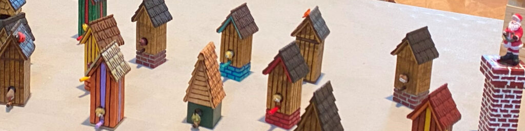 Little wooden birdhouses carved by Richard Riley.