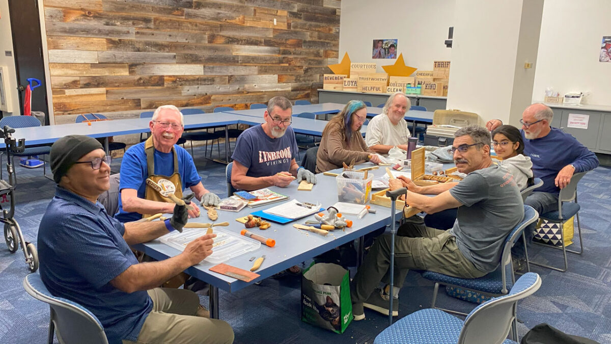 SCVC woodcarving meeting with almost a dozen woodcarvers sitting around a table. May 2025.
