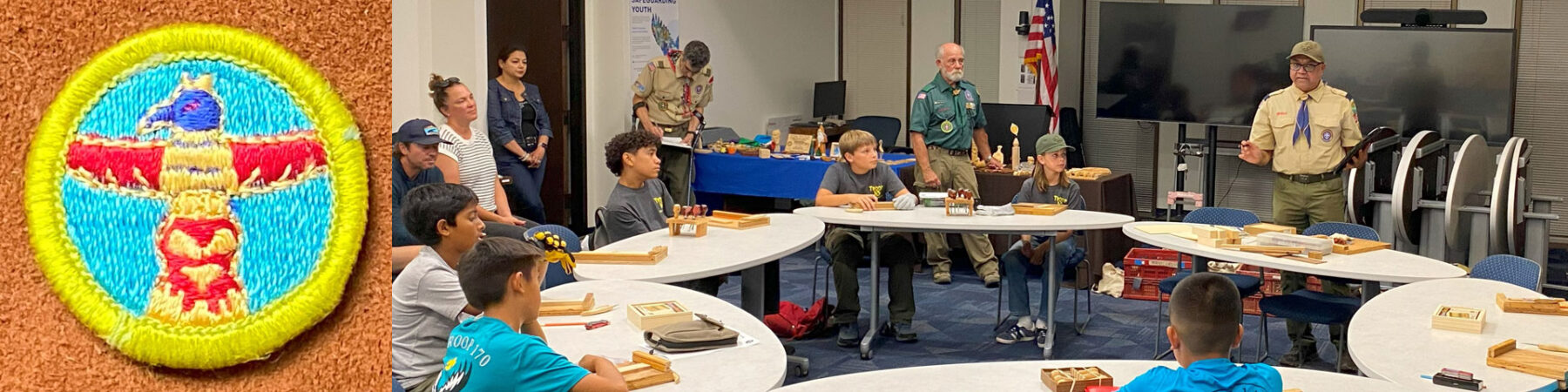 A photo of the Wood Carving Merit Badge and several scouts learning woodcarving in a room.