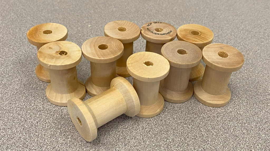 Ten wooden spools